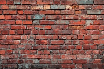 Naklejka premium Red brick wall with aged texture. Great for backgrounds and design projects.