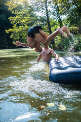 Fototapeta premium a boy bathes in a river in the summer on a hot day 