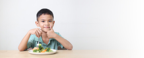 Nutrition healthy eating habits for kids concept. Children do not like to eat vegetables. Little cute boy refuses to eat healthy vegetables.