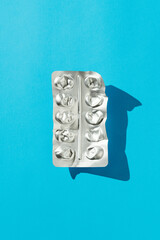 Directly above table top shot of empty blister pack on blue background