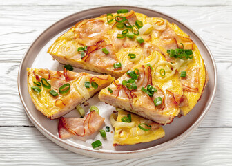 deli ham onion omelette on skillet, top view