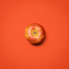 Above, apple and fresh in studio for nutrition, healthy eating and gut health. Fruit, produce or snack on red background for fiber, digestion aid or antioxidants in diet with sweet food with juice