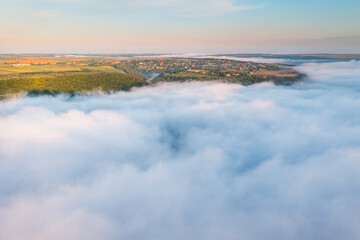 Majestic scene of plain in the fog from a bird's eye view.