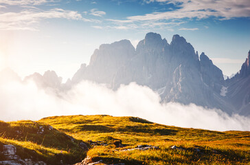 An unusual view of the rocky mountains on a foggy morning. Location place Dolomites, South Tyrol,...