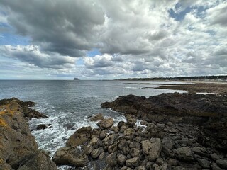 Rocky beach on the coast of Firth of Forth with a view to Bass Rock near North Berwick, Scotland,...