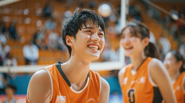 Japanese male and female basketball players have fun and smile at the sports training ground.