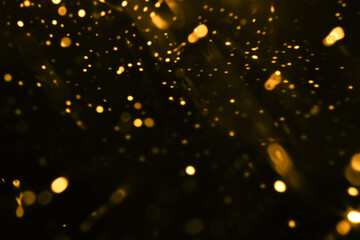 Black background with lots of golden lights. Abstract transition or overlay light effect with...