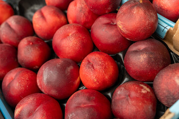 bunch of red peaches are piled on top of each other