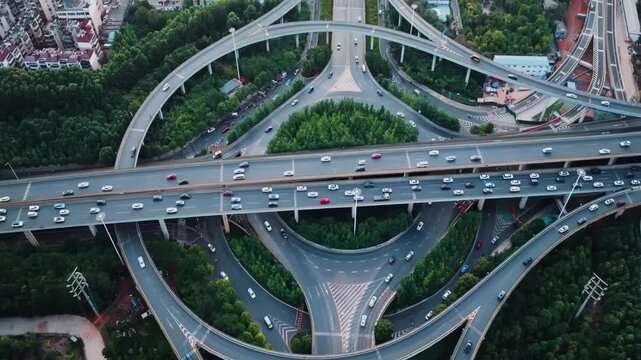 Aerial photography of urban atmosphere viaduct busy multilevel interchange overpass in Shanghai showing morning traffic flow coming from the elevated roads