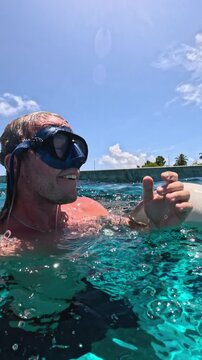 Huge stingray attacking a young man on the water surface in the ocean