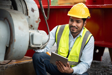 India Asia engineer man worker checking machine and use tablet computer with spare crane background	