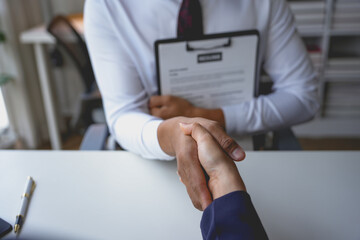 Manager is shaking hands with a job applicant after a successful job interview