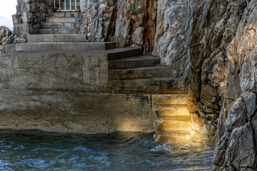 Dangerous descent down steep stairs to a small beach