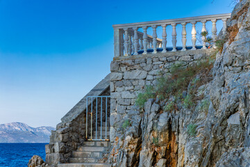 Dangerous descent down steep stairs to a small beach