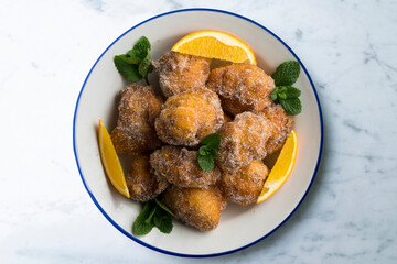 Delicious traditional Spanish fritters. Table decorated with Christmas decorations.