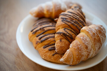 Croissants on a plate on a wooden table