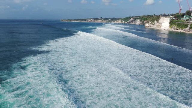 Drone view of coastline with cliffs and ocean with surfing waves in Bali, Impossible beach