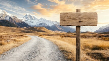 A wooden signpost stands on a dirt road leading towards a majestic mountain range, with a vibrant sunset sky in the background.
