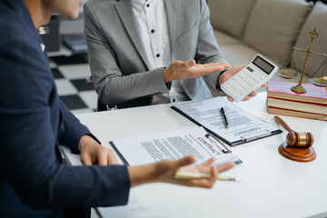 Business people and lawyers discussing contract papers sitting in the table at office, concepts of law, advice, legal services.