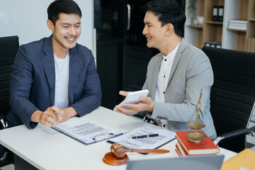 Business people and lawyers discussing contract papers sitting in the table at office, concepts of law, advice, legal services.