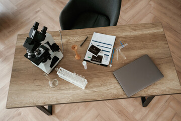 Microscope and laptop. Doctor's equipment, objects on the table
