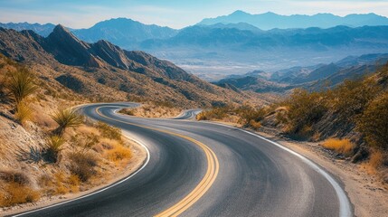 Scenic mountain road with sweeping curves surrounded by vast open spaces. Great for road trip and travel guides