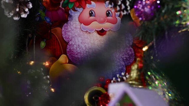 Christmas tree branches rotate against a large image of Santa Claus