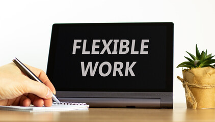 Flexible work symbol. Concept words Flexible work on beautiful black pad. Beautiful white background. Businessman hand. Business Flexible work concept. Copy space.