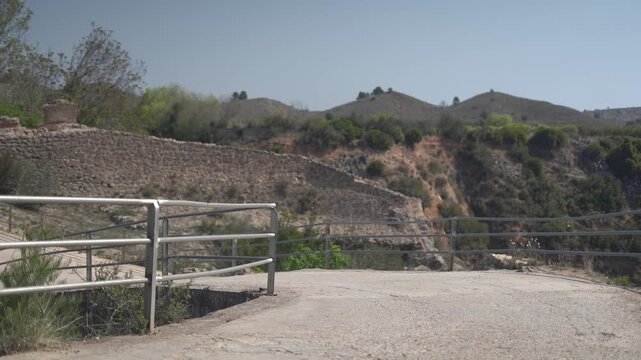 Motorcycle rider passing a rural bridge