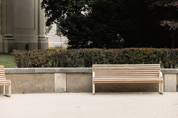 Modern benches in the city square on a sunny day. City improvement, urban planning, public spaces.