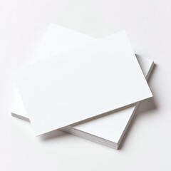 A stack of blank white paper sheets name card on a clean surface, perfect for printing, drawing, or any creative project.