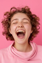 Portrait Of A Beautiful Young Woman Against A Light Pink Background, Happy And Smiling, Shouting With Her Mouth Wide Open