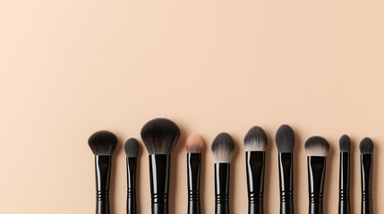 Set of makeup brushes neatly arranged on a beige background.