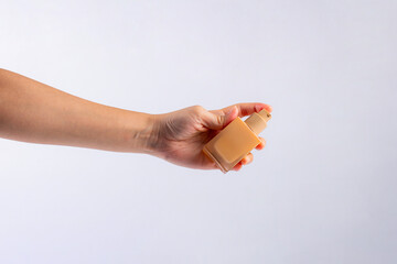 Cosmetic cream tube in womans hand on white background 