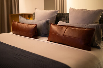 leather pillows cushions neat modern bed blue blanket topsheet sheets hotel room