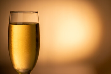 Chilled champagne glass on the left side, sparkling against a golden gradient background. Ideal for New Year’s Eve and Christmas celebrations.