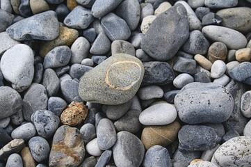 Sea stones background.  Flat lay of colorful sea stones texture background. Pebbles background.
