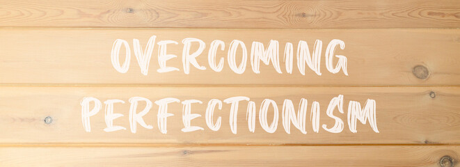Overcoming perfectionism symbol. Concept words Overcoming perfectionism on beautiful wooden wall. Beautiful wooden wall background. Business Overcoming perfectionism concept. Copy space.