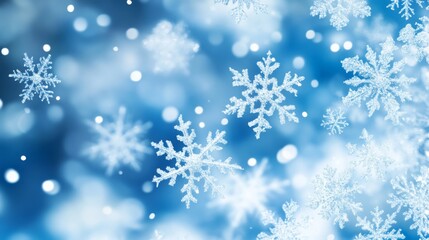 Snowflakes falling on blue background with bokeh effect