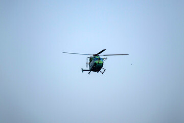Helicopter flying on isolated blue sky