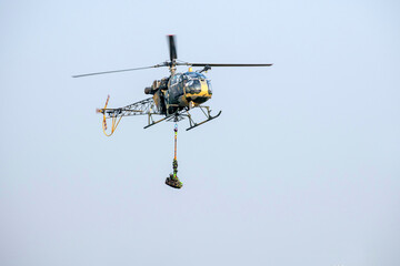 Fototapeta premium Helicopter rescue every day utensils on isolated blue sky