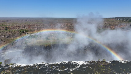 Colorful Rainbow At Livingstone In Northern Rhodesia Zambia. Giant Waterfalls. Nature Landscape. Livingstone At Northern Rhodesia Zambia. Zambezi River. Travel Scenery.