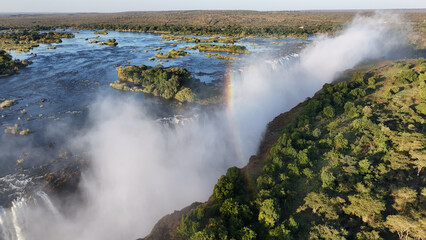 Rainbow In Waterfall At Victoria Falls In Matabeleland North Zimbabwe. Giant Waterfalls. Nature Landscape. Victoria Falls At Matabeleland North Zimbabwe. Zambezi River. Travel Scenery.