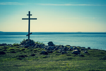 Old wooden cross on the shore of the White Sea.