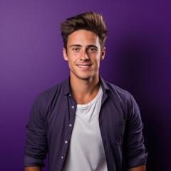 Fototapeta premium A young man with styled hair smiles confidently against a purple background suitable for lifestyle, fashion, and professional branding uses,