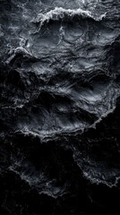 Dark sea waves crashing creating white foam texture