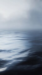 Dark blue ocean water surface merging with foggy sky