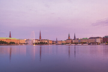 Waterfront view of the old town of Hamburg city at dusk and during the golden hour with a touch of purple color on the sky