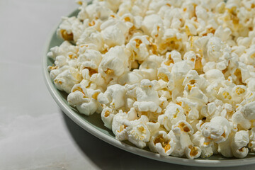 Plate of popcorn on a light background