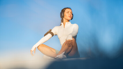 Fototapeta premium Yoga outdoors. Woman sits in lotus position zen gesturing. Concept of healthy lifestyle and relaxation